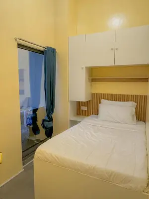 a bedroom with a white bed and a window at Hostel with Private Room near Downtown Business Bay in Dubai
