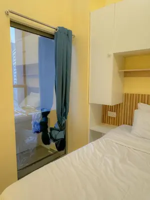 a bedroom with a bed and a window with a curtain at Hostel with Private Room near Downtown Business Bay in Dubai
