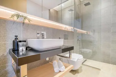 a bathroom with a sink and a toilet at Stella Stays Al-Barari in Dubai