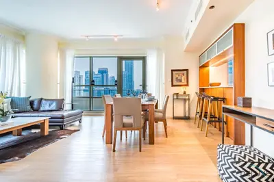 a living room with a couch and a table at Beautiful 2BR apartment in Al Sahab 2, Dubai Marina by Deluxe Holiday Homes in Dubai