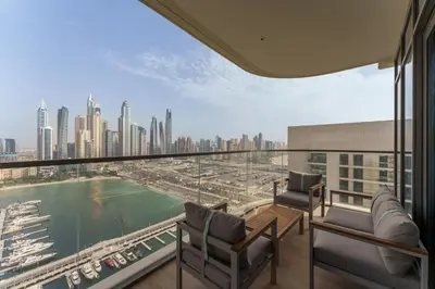 a balcony with chairs and a view of the city at Maison Privee - Exclusive Apt w/ Unmatched Dubai Marina Vistas in Dubai