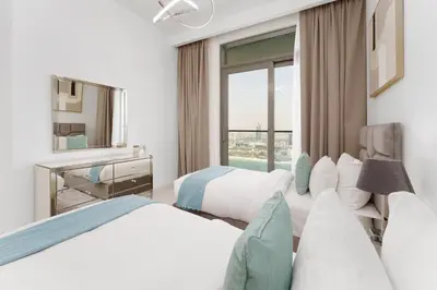 a hotel room with two beds and a mirror at Maison Privee - Exclusive Apt w/ Unmatched Dubai Marina Vistas in Dubai