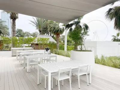 a row of white tables and chairs on a patio at La Vie, JBR in Dubai