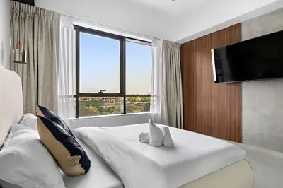 a bedroom with a white bed with a large window at Amazing 1br located in the heart of Dubai,JLT in Dubai