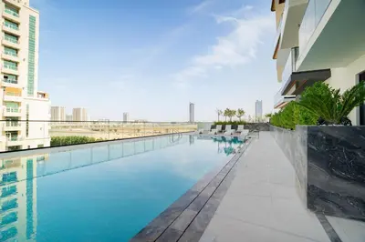 a swimming pool in the middle of a building at CitiHome - 1BR Freshly Styled and Comfortable in JVC in Dubai