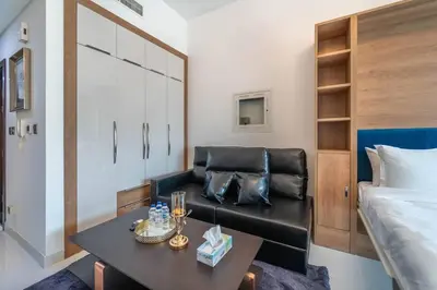 a living room with a couch and a bed at Studio Apartment in Resotz Residence Arjan - Close to Miracle Garden in Dubai
