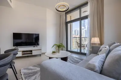 a living room with a couch and a large window at Apartment with Burj Khalifa View I Bellevue Tower in Dubai