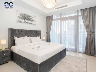 a bedroom with a large bed and a large window at Paramount Downtown Burj Khalifa View with 64th floor Infinity pool in Dubai