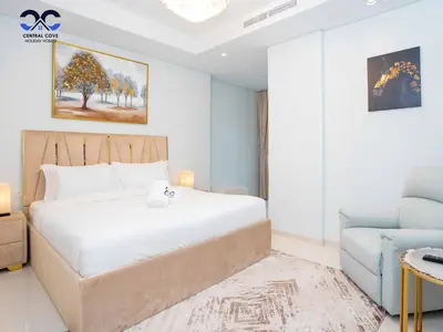 a bedroom with a bed and a blue chair at Paramount Downtown Burj Khalifa View with 64th floor Infinity pool in Dubai