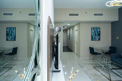 two views of a hallway in a building at Escape24 Studio at Loreto with Community View in Dubai