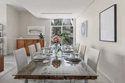 a dining room with a wooden table and chairs at GuestReady - Luxury haven at Marina Arcade in Dubai