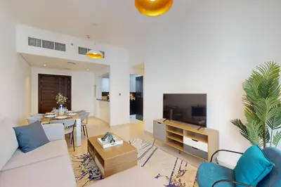 a living room with a couch and a table at Silverene Tower B - Bright Two Bedroom in Dubai