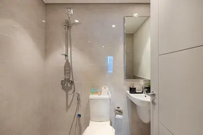 a bathroom with a toilet and a sink at Luxury 4BR Burj Khalifa & Fountain Views in Dubai