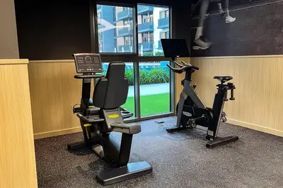 a gym with two exercise bikes and a laptop at Brand New 1 Bedroom Apartment JVC in Dubai