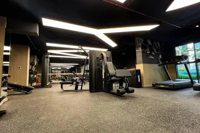 a gym with treadmills and machines in a room at Brand New 1 Bedroom Apartment JVC in Dubai