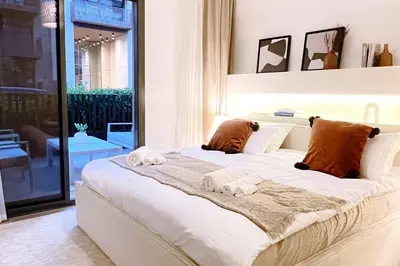 a bedroom with a large bed with towels on it at Brand New 1 Bedroom Apartment JVC in Dubai