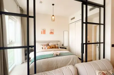a bedroom with a bed and a couch at Brand New Apartment in Socio Tower Dubai Hills in Dubai