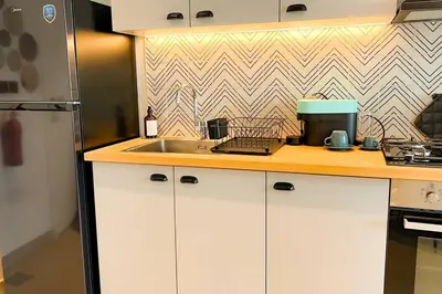 a kitchen with a sink and a counter top at Brand New Apartment in Socio Tower Dubai Hills in Dubai