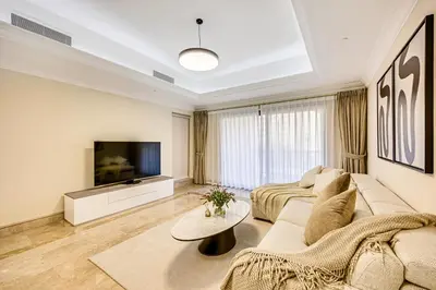 a living room with a couch and a tv at Spacious 1BD apartment in the Residence North in Dubai