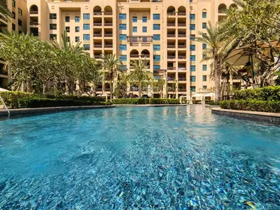 a large swimming pool in front of a building at Spacious 1BD apartment in the Residence North in Dubai