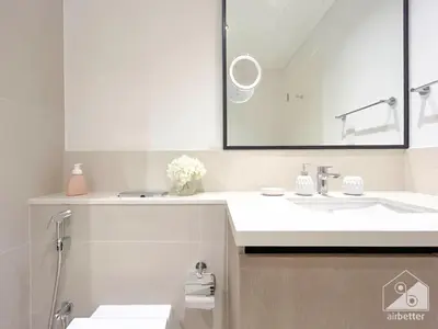 a white bathroom with a sink and a mirror at Luxury Burj Crown 4bedroom Balcony & Downtown View in Dubai