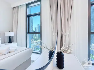 a bedroom with a bed and a large window at Luxury Burj Crown 4bedroom Balcony & Downtown View in Dubai
