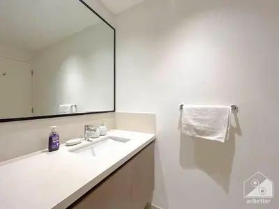 a bathroom with a sink and a large mirror at Luxury Burj Crown 4bedroom Balcony & Downtown View in Dubai