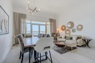 a living room with a table and a couch at Al Hatimi, Shoreline Apartments, Palm Jumeirah, Dubai in Dubai