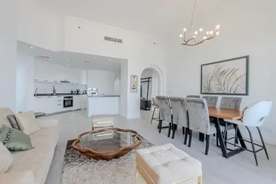 a living room with a couch and a table at Al Hatimi, Shoreline Apartments, Palm Jumeirah, Dubai in Dubai