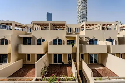 an image of an apartment building with balconies at Modern and Cozy Studio in JVC I Luma Building in Dubai