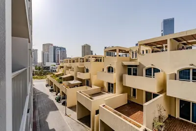 an apartment building with balconies on a city street at Modern and Cozy Studio in JVC I Luma Building in Dubai