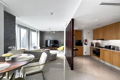a kitchen and living room with a couch and a table at Opera Grand by Emaar LUXURY 1 BR Apartment in Downtown Dubai sea and city view in Dubai
