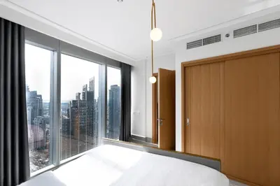 a bedroom with a bed and a large window at Opera Grand by Emaar LUXURY 1 BR Apartment in Downtown Dubai sea and city view in Dubai