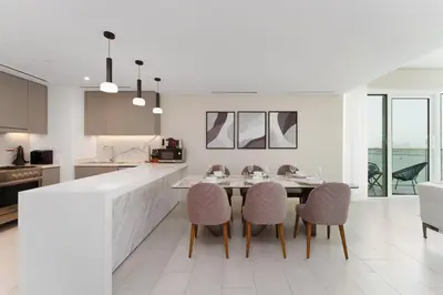 a kitchen with a table and four chairs at Beachfront Luxury Living at La Vie Residence JBR in Dubai