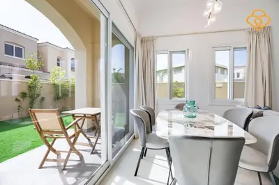 a dining room with a glass table and chairs at Keysplease Beautiful 3 B/R Villa With Garden, Serena in Dubai