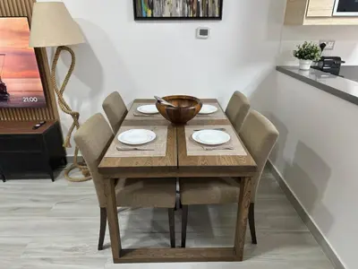 a wooden table with chairs and a bowl on top at Modern 1BR Apartment in Dubai Marina with sea view in Dubai