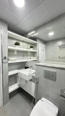 a bathroom with a white sink and a toilet at Modern 1BR Apartment in Dubai Marina with sea view in Dubai