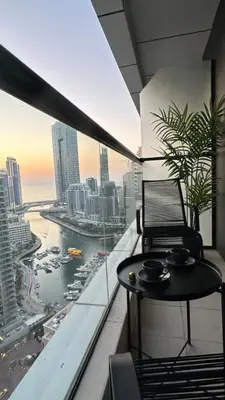 a balcony with a table and a view of the city at Modern 1BR Apartment in Dubai Marina with sea view in Dubai
