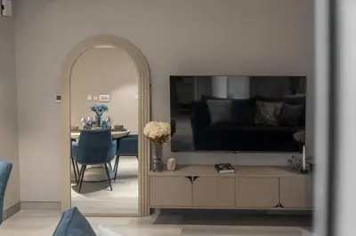 a living room with a large television and a table at Clever Guest 021 Condor Marina Star in Dubai