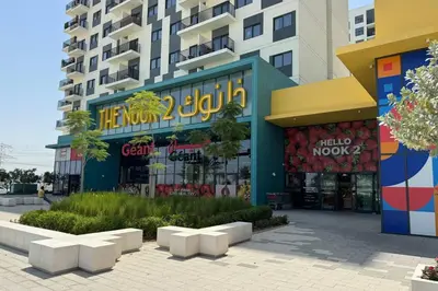 a shopping center in front of a building at Comfortable 2BD apartment next to metro & mall in Dubai