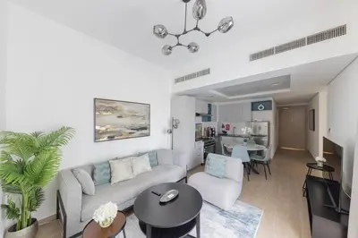 a living room with a couch and a table at Comfortable 2BD apartment next to metro & mall in Dubai