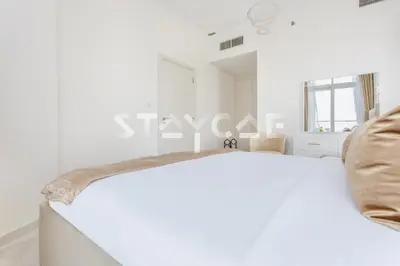 a white room with a couch and a table at Staycae Holiday Homes - Carson Towers in Dubai