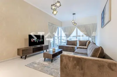 a living room with a couch and a tv at Staycae Holiday Homes - Carson Towers in Dubai