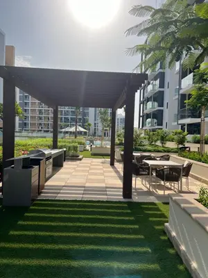 a pavilion with tables and chairs in a park at Luxury Studio Brand New with HighEnd Furnishings in Dubai