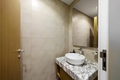 a bathroom with a sink and a mirror at 35th Floor Luxury 2 BR with Stunning Views in Dubai