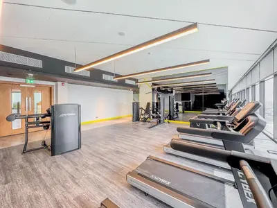 a gym with a row of treadmills at 35th Floor Luxury 2 BR with Stunning Views in Dubai