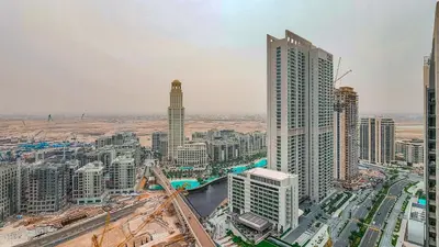 an aerial view of a city with tall buildings at Chic New 2BR Dubai Creek Gate by Tanami Holiday Homes in Dubai