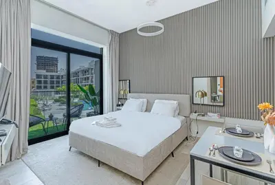 a bedroom with a bed and a large window at Elegant Studio Stay I Pool, Gym & Parking in Dubai