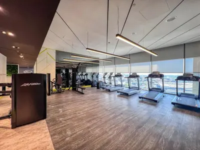 a gym with treadmills and cardio equipment in a building at GuestReady - Contemporary studio in Business Bay in Dubai
