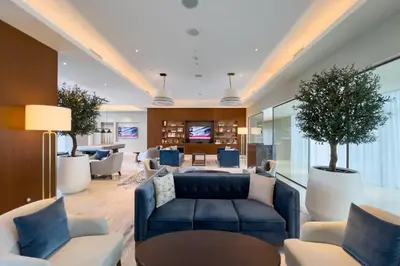 a living room with a blue couch and chairs at GuestReady - Glamorous place near Burj Khalifa in Dubai
